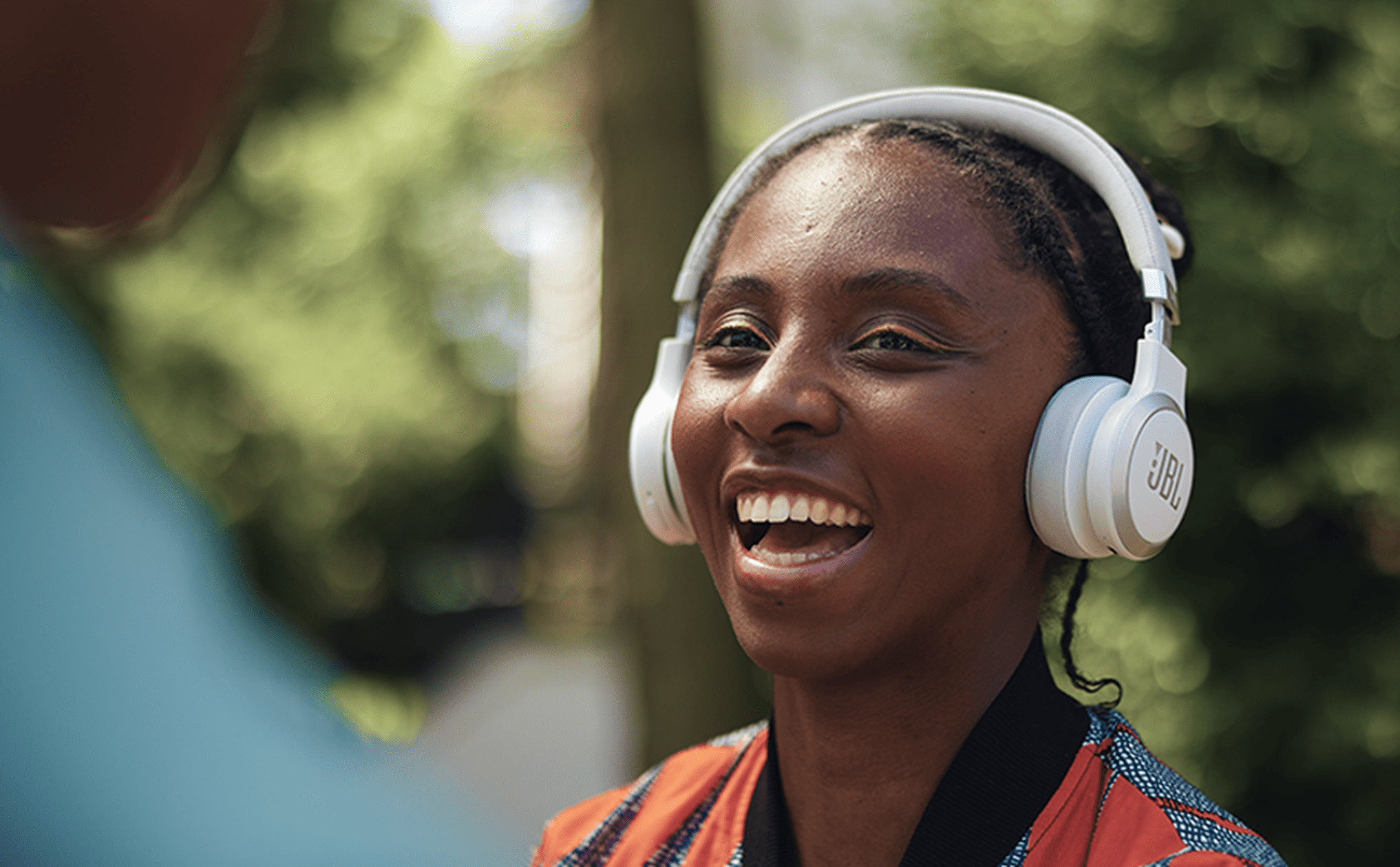 Woman smiles with JBL Live 670NC Headphones